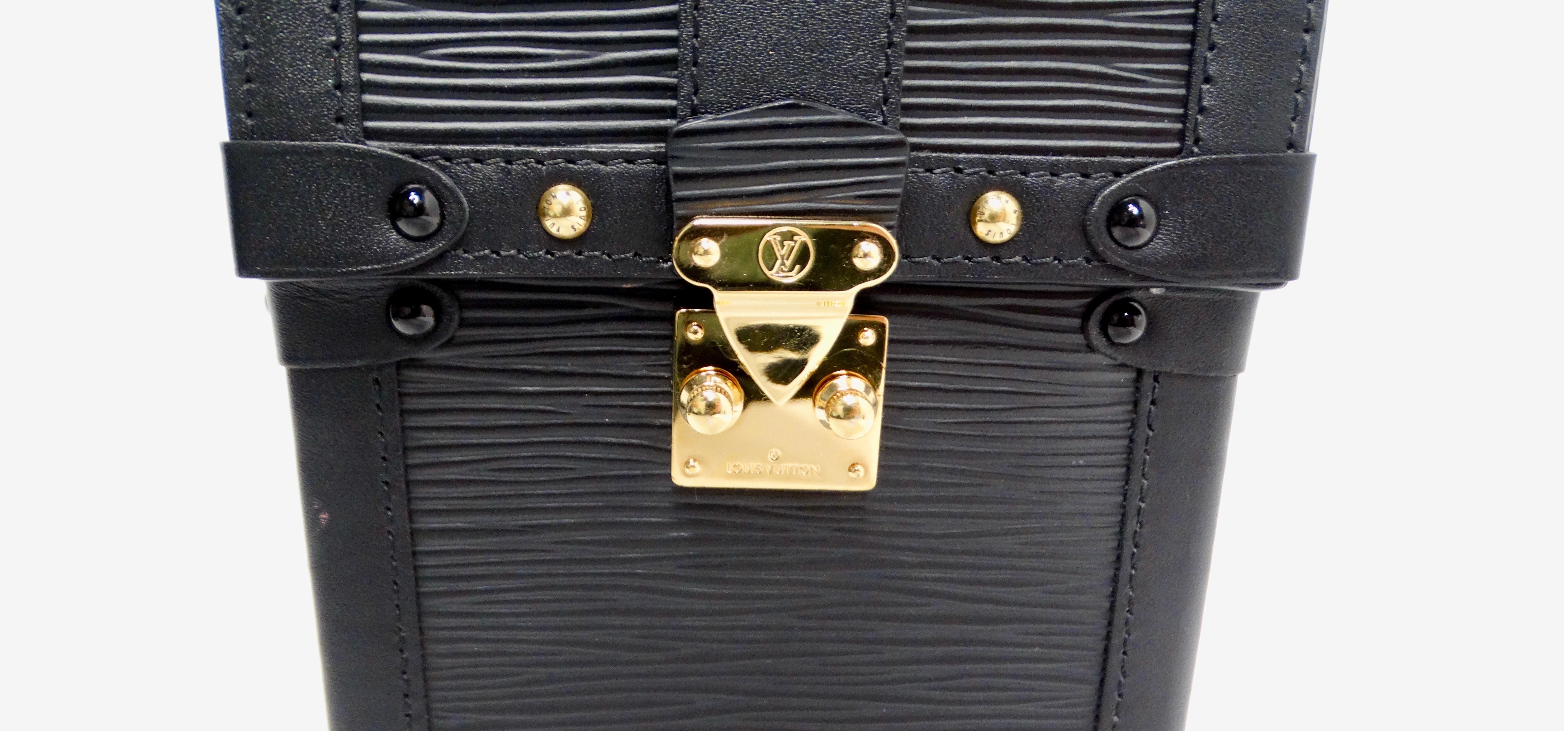 The Louis Vuitton 2019 Epi Vertical Pochette Trunk Crossbody Bag in sleek black Epi leather is the pinnacle of modern luxury and practicality. This mini bag features gold-tone hardware that exudes elegance while being incredibly functional. Designed