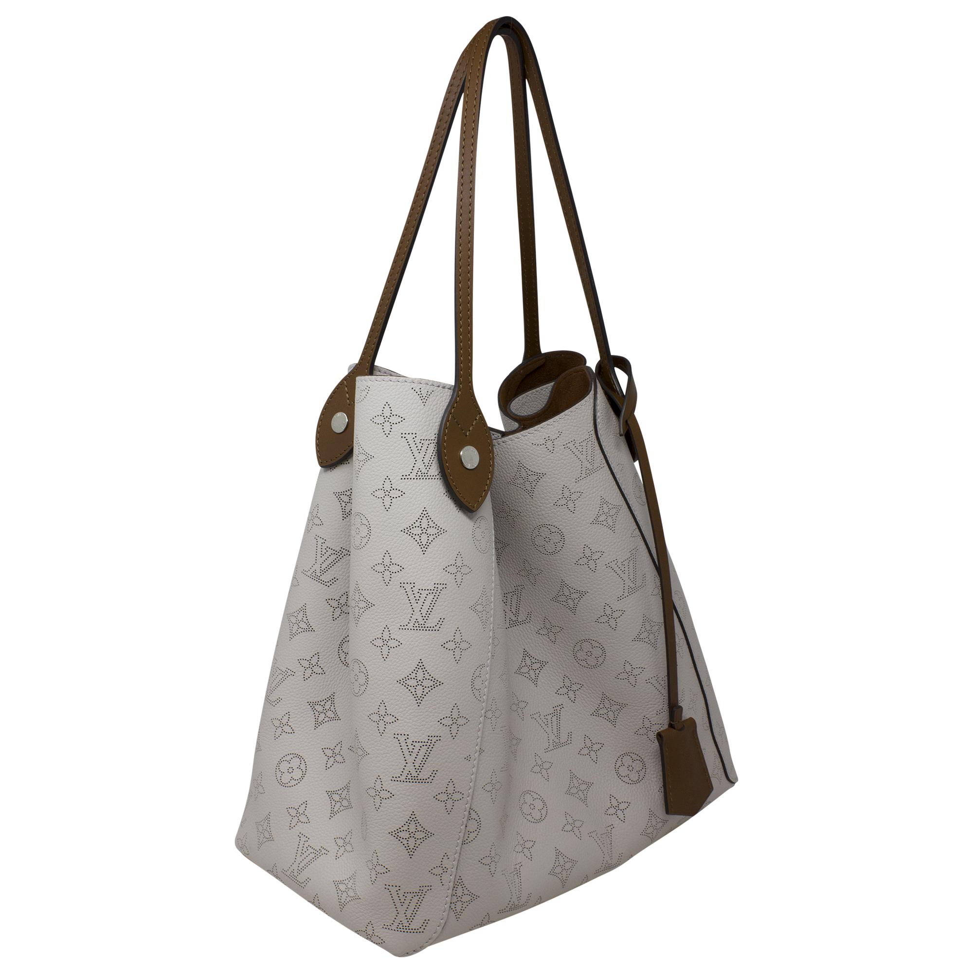 Introducing the Louis Vuitton 2019 Grey Monogram Mahina Hina MM w/ Pouch, a luxurious and versatile accessory for the modern fashionista. Crafted from exquisite grey calfskin leather, this bag showcases Louis Vuitton's iconic Monogram Mahina