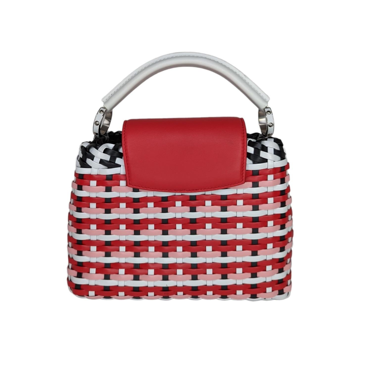 Limited Edition. From the Spring/Summer 2019 Collection. Red and multicolor basket woven Louis Vuitton Capucines Guinguette BB with ruthenium-tone hardware, red Taurillon leather trim, single rolled top handle, black calf leather lining, three