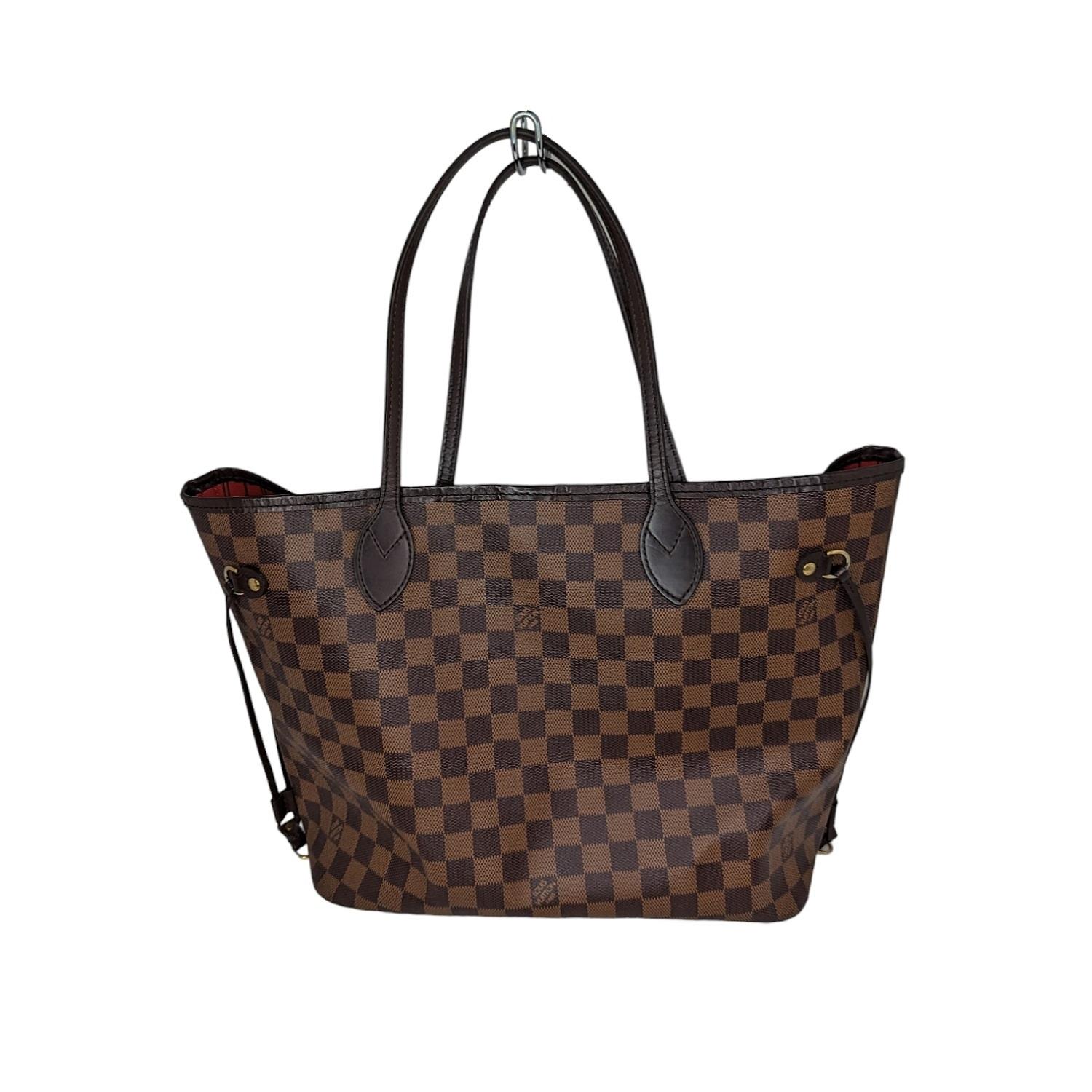 This chic tote is crafted of classic Louis Vuitton Damier in brown on coated canvas. The shoulder bag features chocolate brown cowhide leather trim, shoulder straps, side cinch cords, and has polished brass hardware. The top is open to a striped