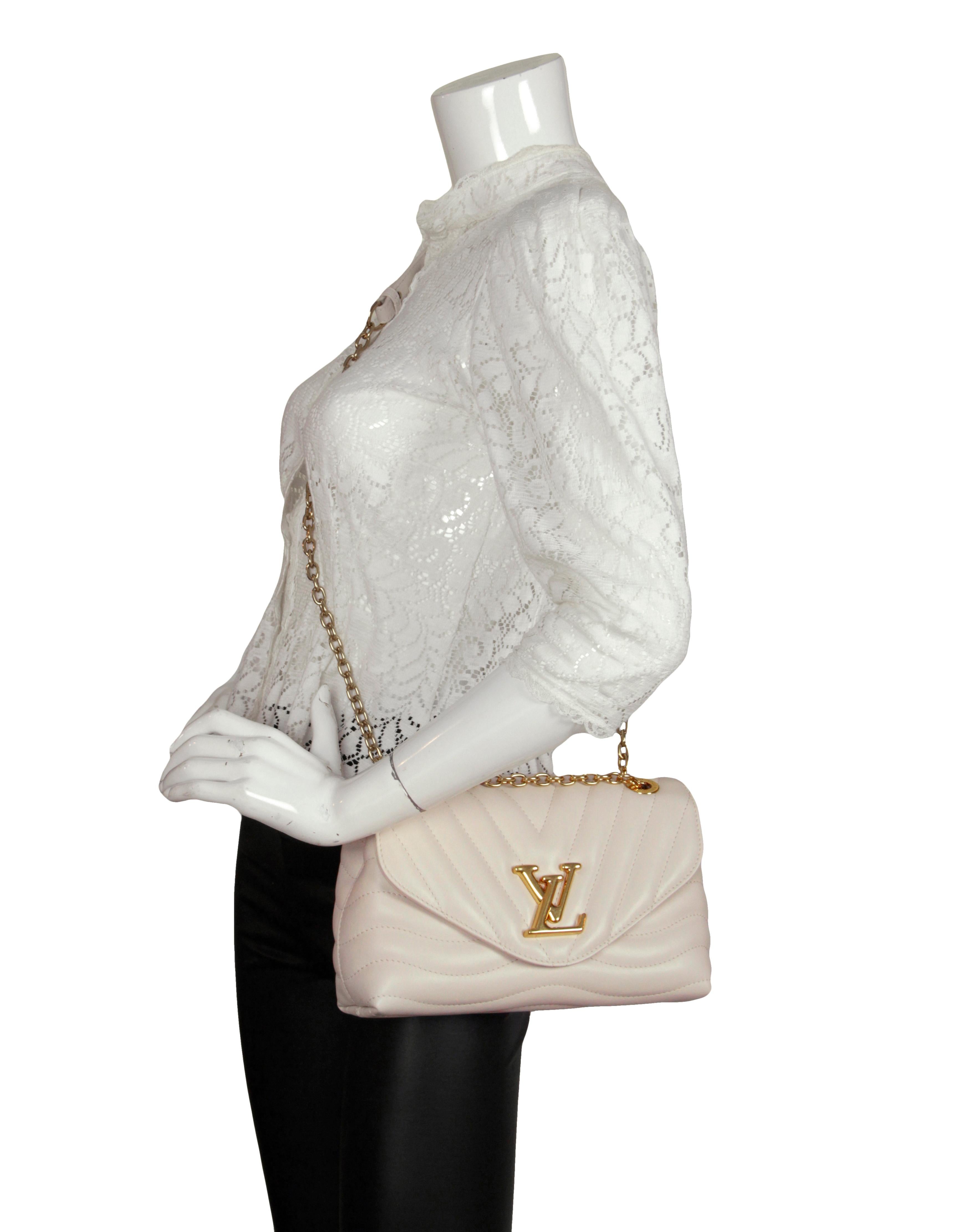 Louis Vuitton Ivorie Calfskin LV New Wave Chain Flap Bag.  Strap can be worn doubled on the shoulder, or singled as a crossbody.

Made In: Italy
Year of Production: 2021
Color: Ivory
Hardware: Goldtone
Materials: Smooth cowhide leather
Lining: