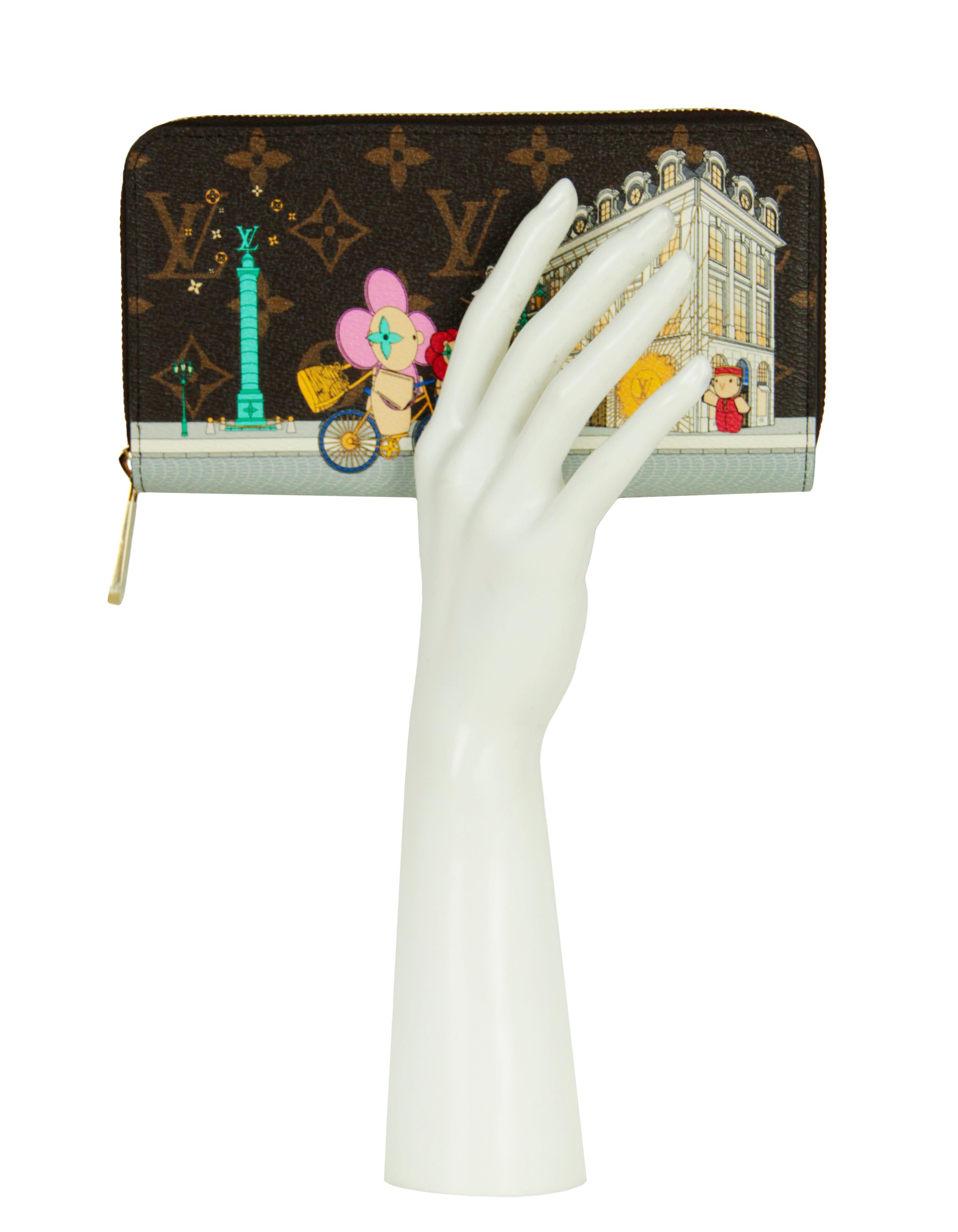 Louis Vuitton 2022 Vivienne Holiday Animation Monogram Zippy Wallet. Features the House's Vivienne mascot in front of the Paris boutique on Place Vendôme.

Made In: France
Year of Production: 2022
Color: Brown and multicolor
Hardware: