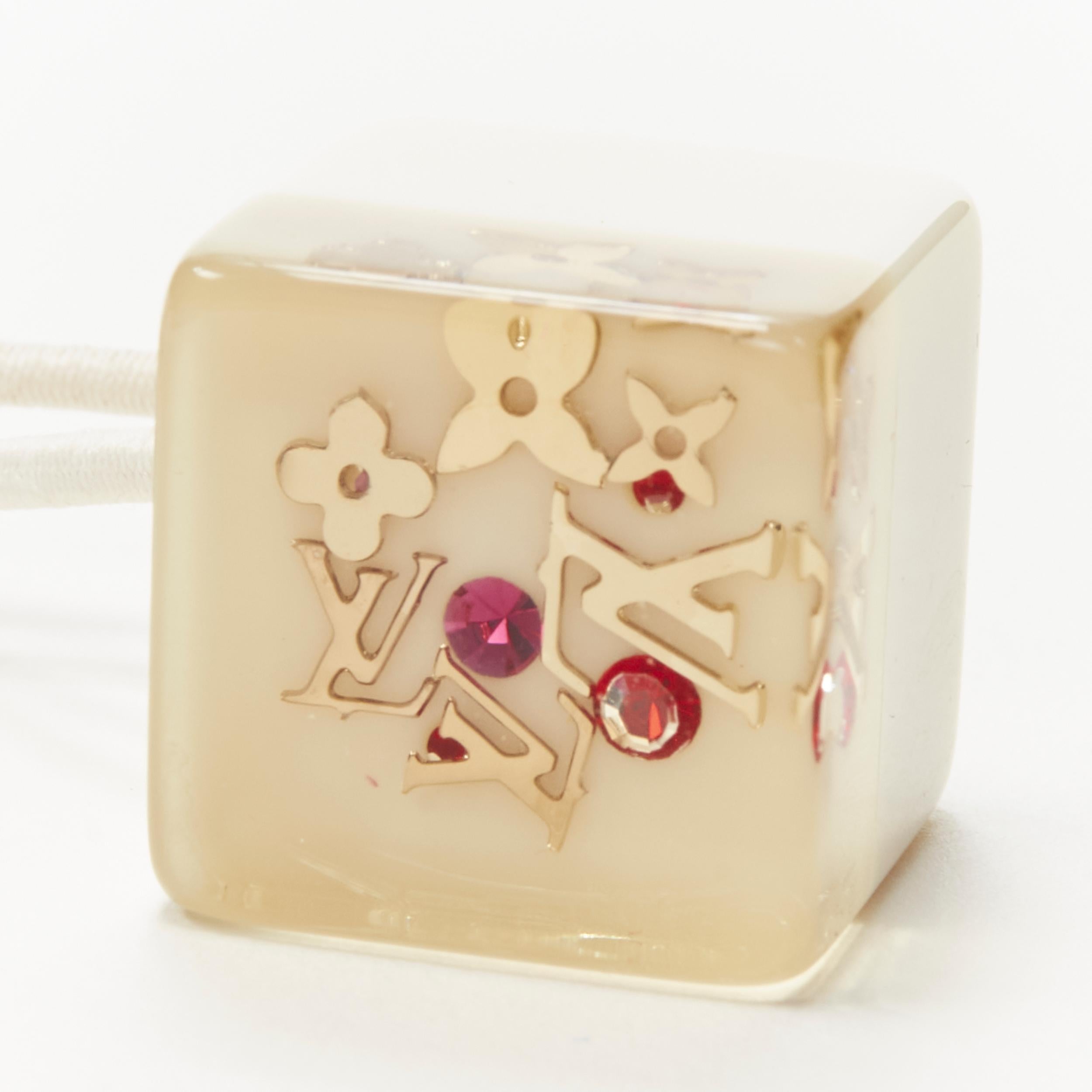 LOUIS VUITTON 2X gold tone LV monogram floral charm hair cube white brown 
Reference: ANWU/A00133 
Brand: Louis Vuitton 
Designer: Marc Jacobs 
Material: Plastic 
Color: Brown 
Pattern: Solid 
Made in: France 


CONDITION: 
Condition: Very good,