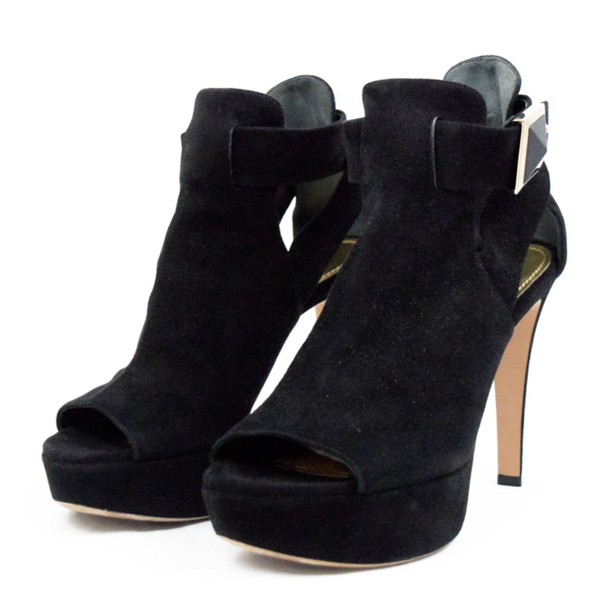 Black pumps with square logo buckle. 
Material: Suede
Heel type: Open-toe cutout sandals
Size: EU 37.5
Heel length: 12cm
Includes (extras): Dust bag
Overall Condition: Good
Interior Condition: signs of use
Exterior Condition: Aging in the suede.

