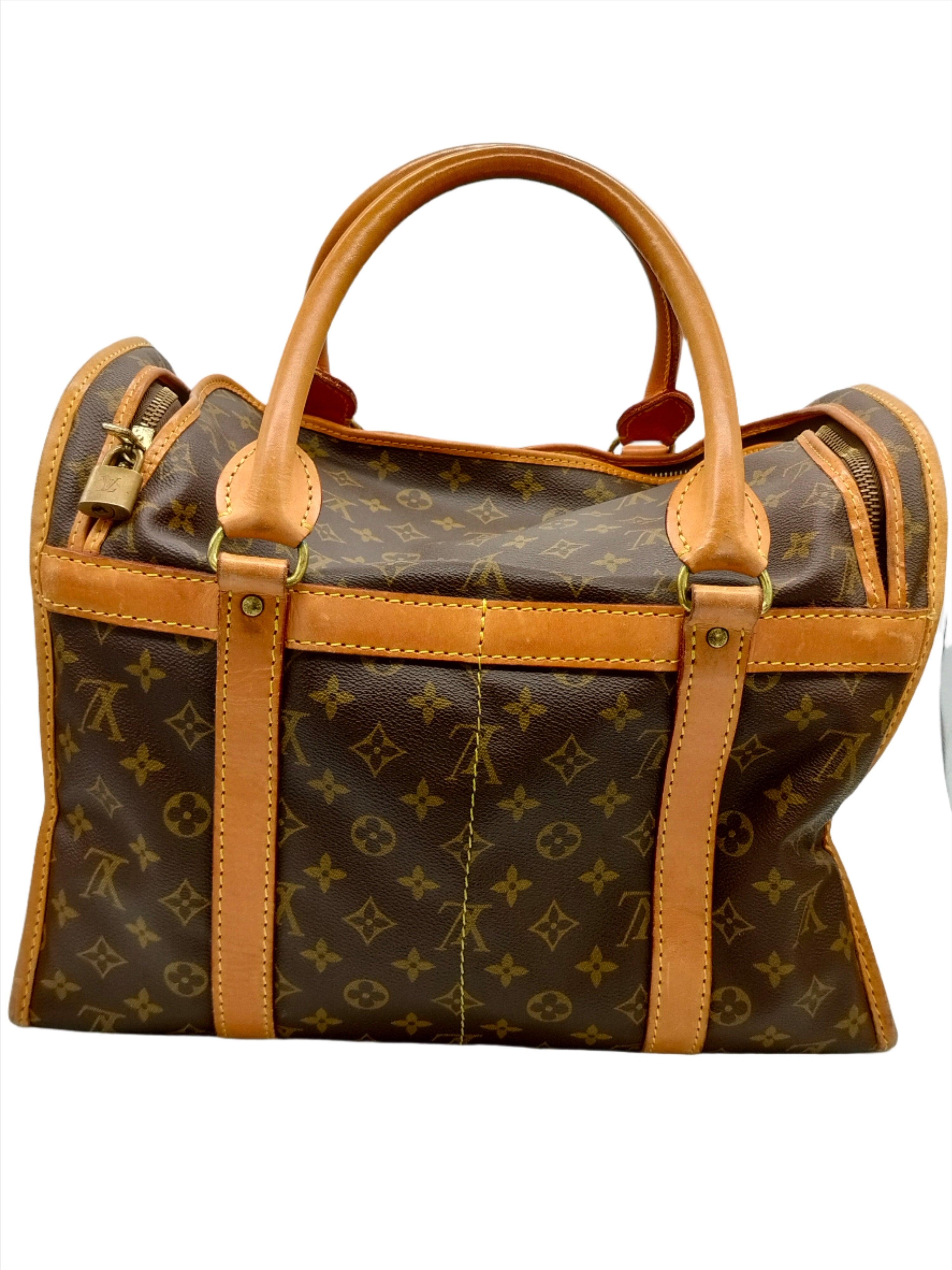 Louis Vuitton Dog Bag 50, iconic brown Monogram canvas, natural leather trimmings, gold-tone hardware, top zipper closure, breathable mesh sides, washable fabric lining, practical way to travel with your pet! Remarks: Bottom wear, handle