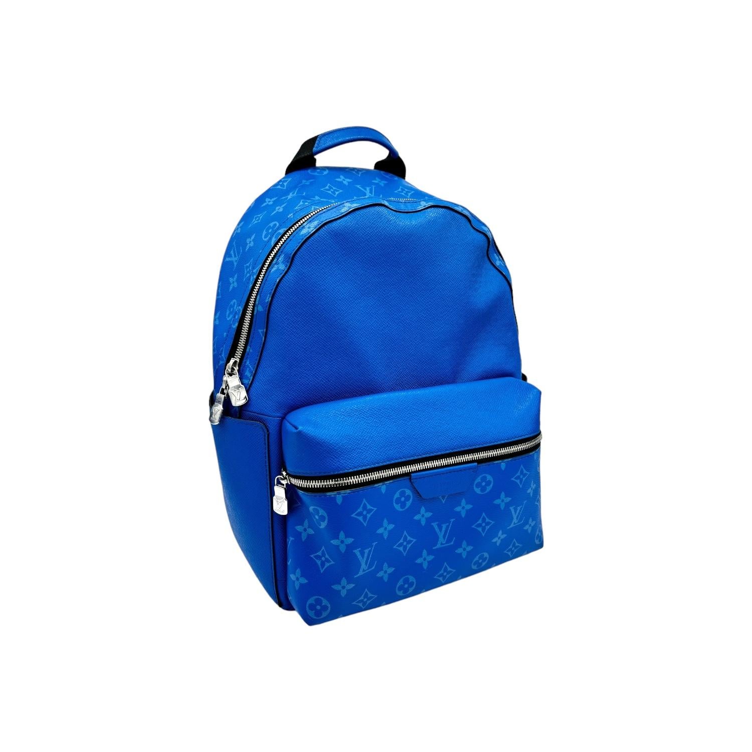 Upgrade your style with the Louis Vuitton Agave Blue Discovery Backpack PM. Crafted from luxurious Taiga Cowhide Leather and Monogram Coated Canvas, this designer backpack features a single zip pocket and dual side pockets on the exterior for easy