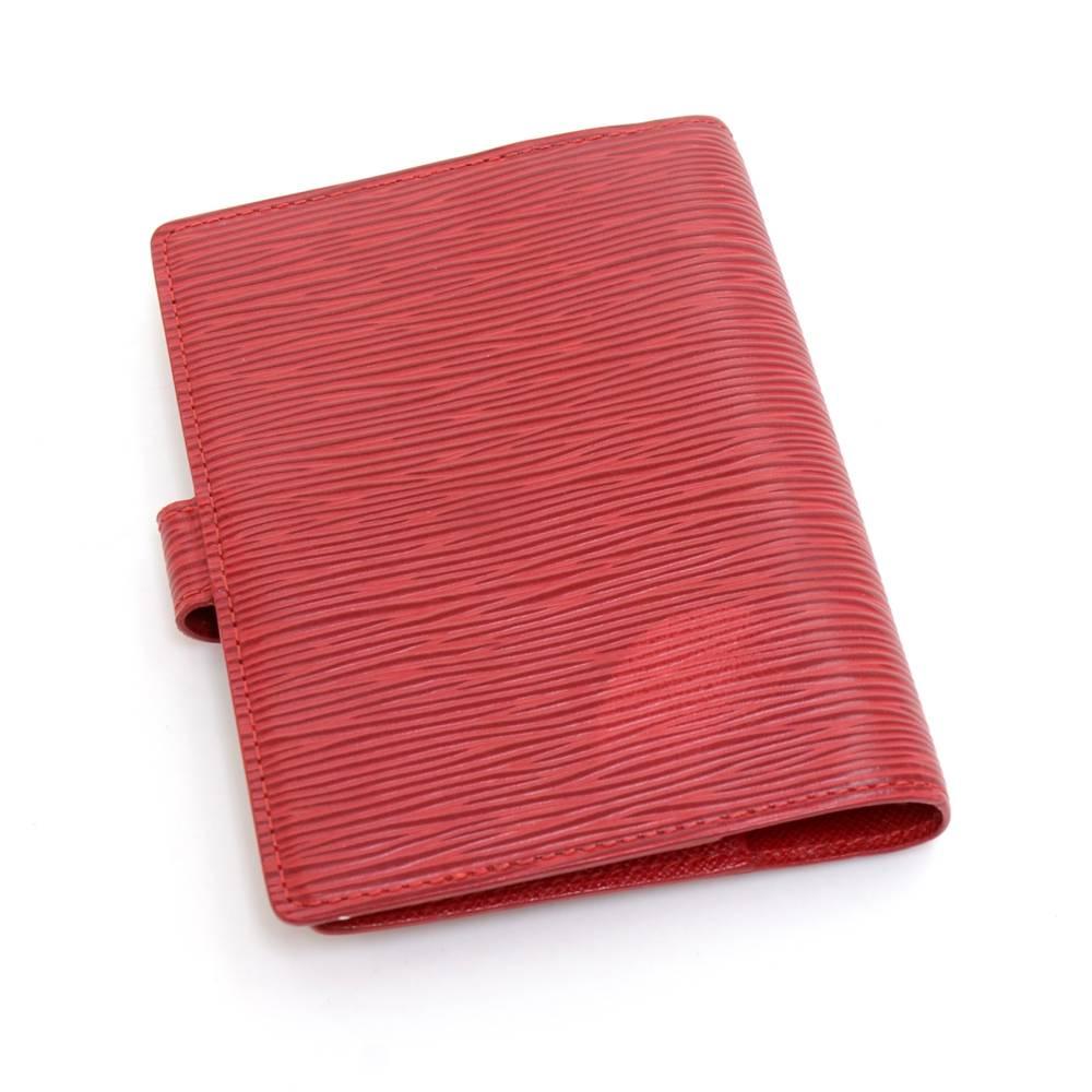 Louis Vuitton agenda in Red Epi leather with 6 rings. It has 3 credit card slots, 2 open side pockets,a pen holder, and has a stud closure. it can hold your schedule, addresses, or notes.  The small 6-ring refill papers can be bought at the LV store