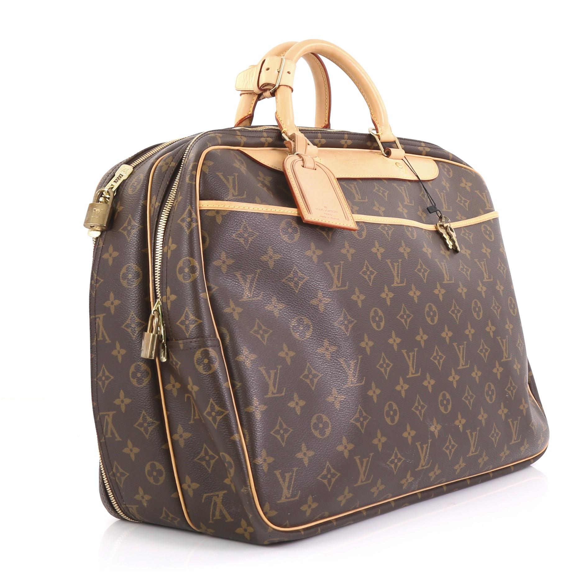 This Louis Vuitton Alize Bag Monogram Canvas 24 Heures, crafted from brown monogram coated canvas, features dual rolled leather handles, exterior front slip pocket, and gold-tone hardware. Its two-way zip closure opens to a beige canvas interior