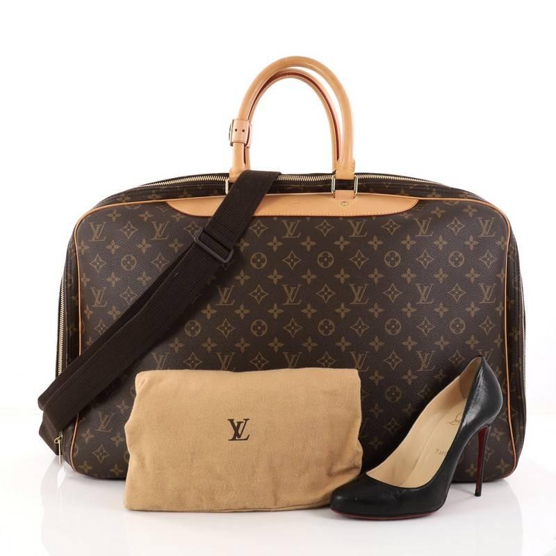 This authentic Louis Vuitton Alize Bag Monogram Canvas 3 Poches is your luxurious companion made for getaways. Crafted in Louis Vuitton's iconic brown monogram coated canvas with vachetta handles and trims, this soft suitcase features dual-rolled