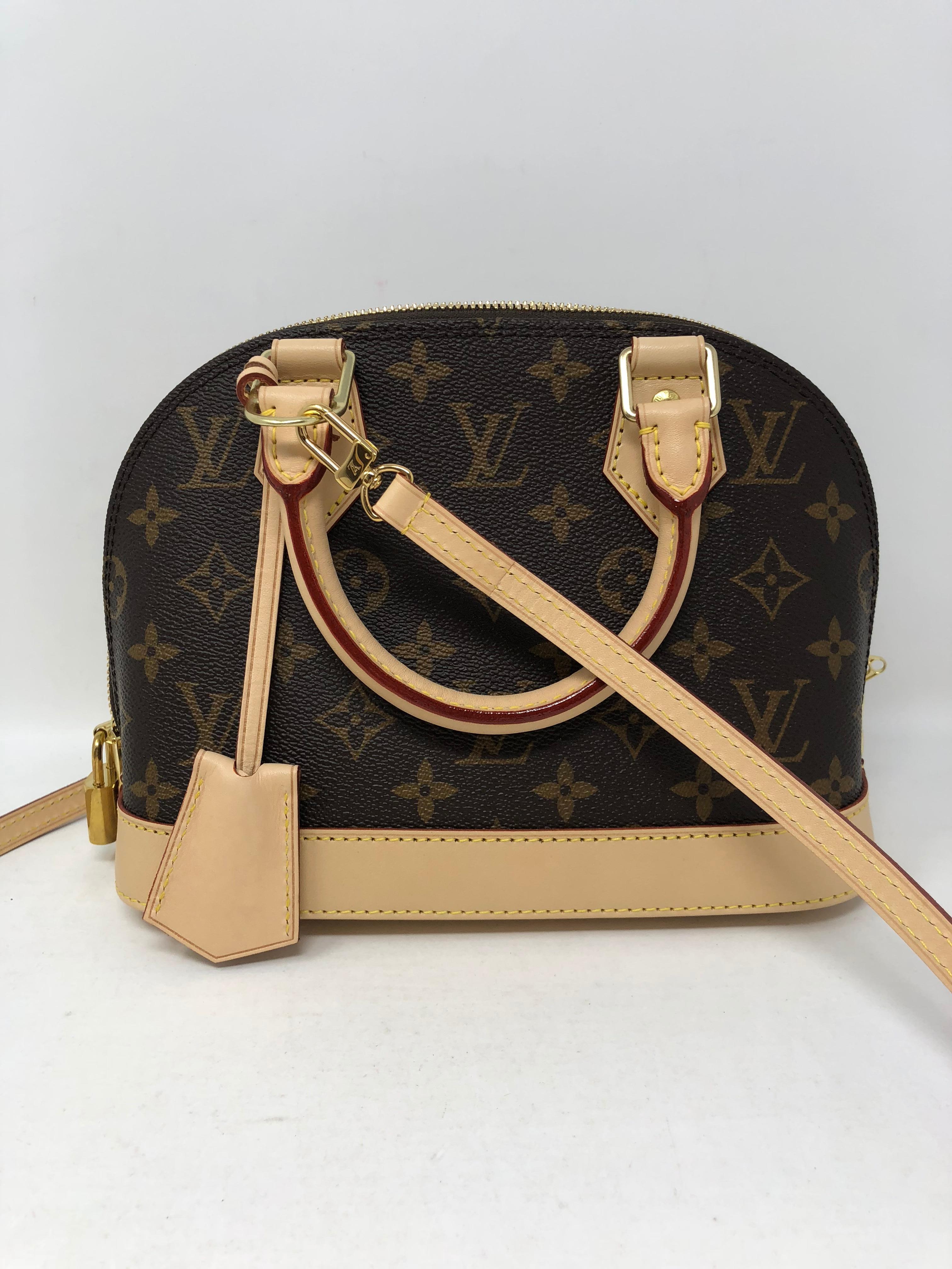 Louis Vuitton Alma BB Crossbody in Monogram. Sold out and very limited. This is the miniature version of the Art Deco icon from 1934. Comes with the strap that makes it a hands free solution. Date code is AA 4148. Lock and key and clochette included