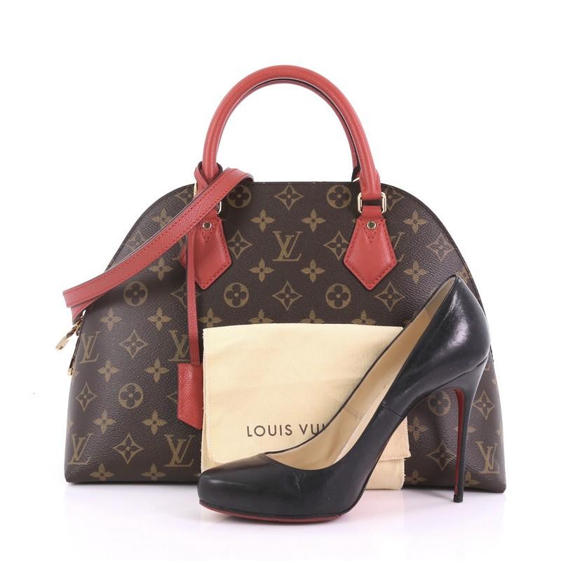 This Louis Vuitton Alma BNB Handbag Monogram Canvas, crafted from brown monogram coated canvas and red leather, features dual rolled handles, two side exterior compartments, and gold-tone hardware. Its two-way zip closure opens to a red microfiber