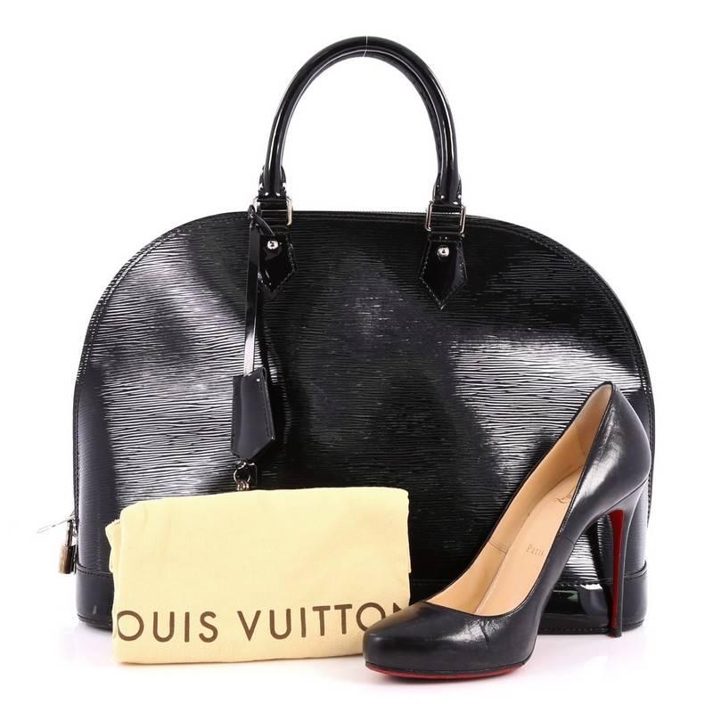 This authentic Louis Vuitton Alma Handbag Electric Epi Leather GM is as elegant and classic as they come. Constructed with Louis Vuitton's signature noir black electric epi leather, this bag features a structured dome-like silhouette, dual-rolled