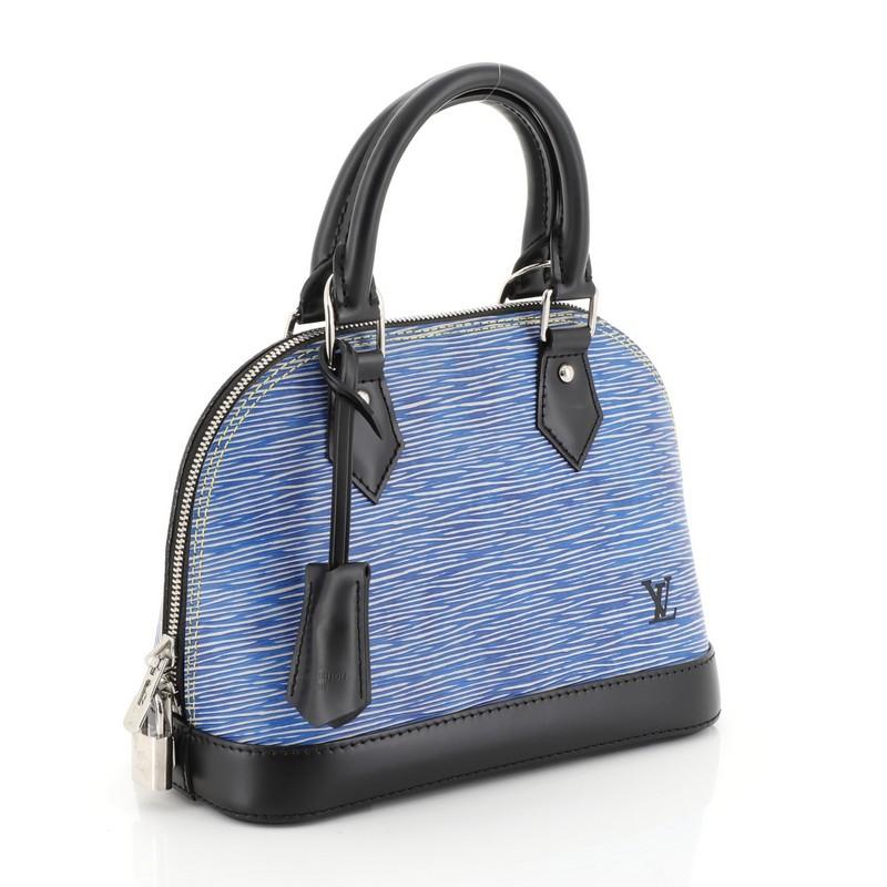This Louis Vuitton Alma Handbag Epi Leather BB, crafted in blue epi leather, features dual rolled leather handles and silver-tone hardware. Its all-around zip closure opens to a black microfiber interior with slip pocket. Authenticity code reads: