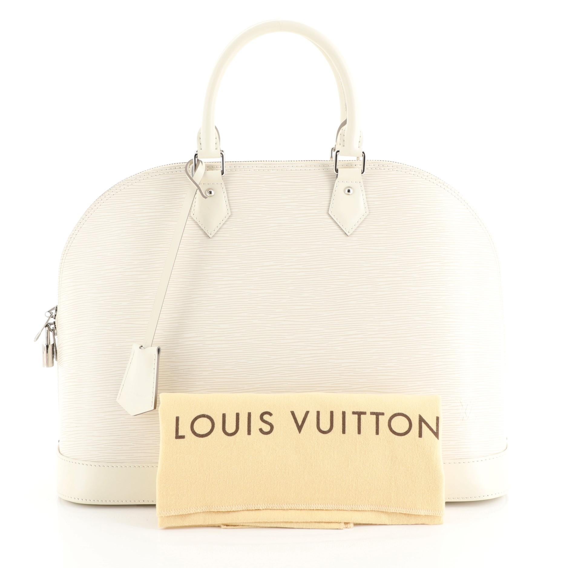 This Louis Vuitton Alma Handbag Epi Leather MM, crafted in white epi leather, features dual rolled handles, protective base studs, and silver-tone hardware. Its all-around zip closure opens to a gray microfiber interior with slip pockets.