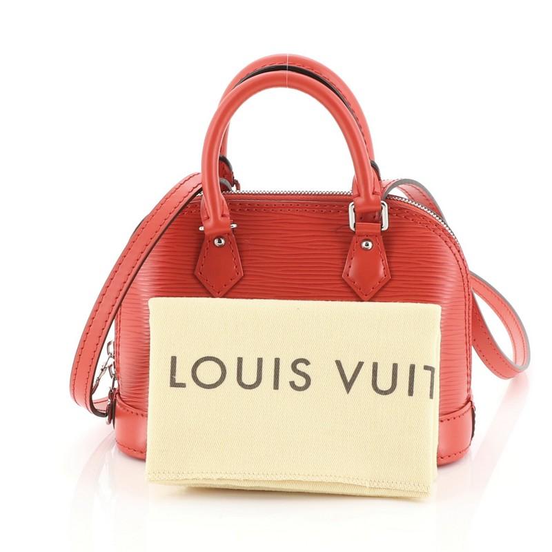 This Louis Vuitton Alma Handbag Epi Leather Nano, crafted in red epi leather, features dual rolled leather handles and silver-tone hardware. Its all-around zip closure opens to a red microfiber interior. Authenticity code reads: SN3175. 

Estimated