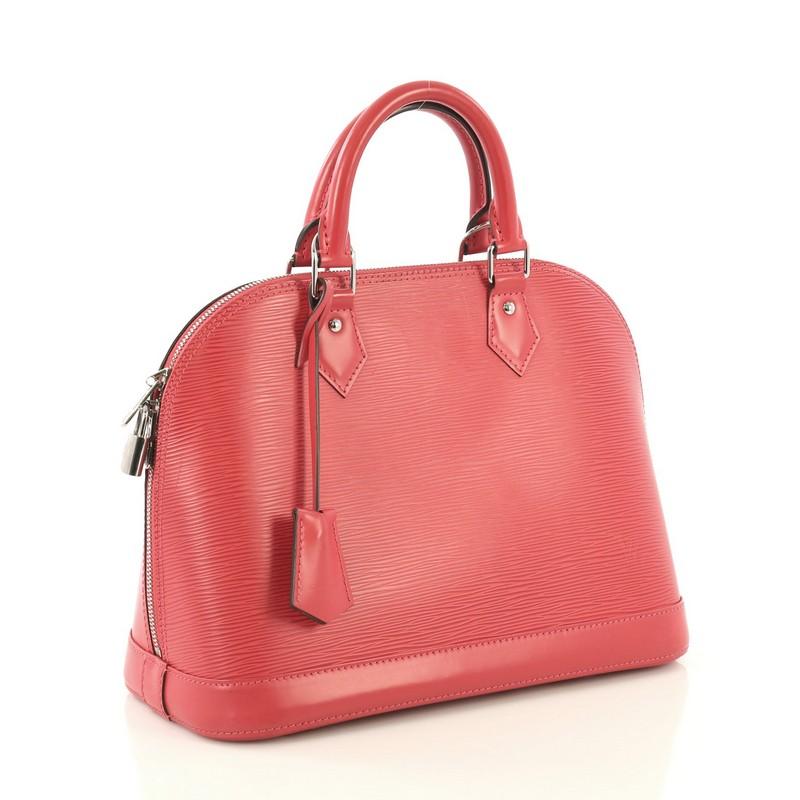 This Louis Vuitton Alma Handbag Epi Leather PM, crafted in pink epi leather, features dual rolled leather handles, protective base studs, and silver-tone hardware. Its all-around zip closure opens to a pink microfiber interior with slip pockets.