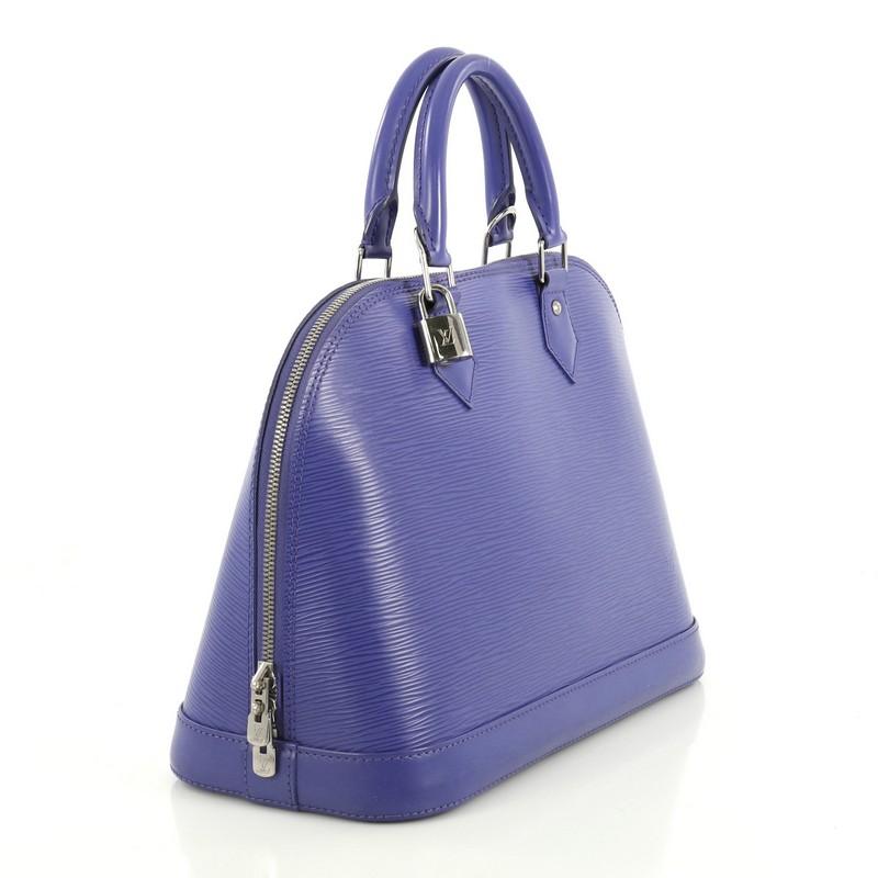 This Louis Vuitton Alma Handbag Epi Leather PM, crafted in purple epi leather, features dual rolled leather handles, protective base studs, and silver-tone hardware. Its all-around zip closure opens to a purple microfiber interior with slip pockets.