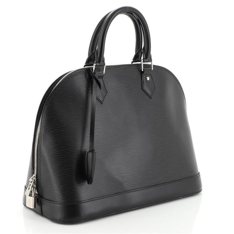 This Louis Vuitton Alma Handbag Epi Leather PM, crafted in black epi leather, features dual rolled leather handles, protective base studs, and silver-tone hardware. Its all-around zip closure opens to a gray microfiber interior with slip pockets.