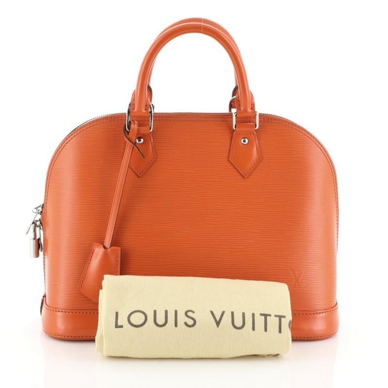 This Louis Vuitton Alma Handbag Epi Leather PM, crafted in orange epi leather, features dual rolled leather handles, protective base studs, and silver-tone hardware. Its all-around zip closure opens to a orange microfiber interior with slip pockets.