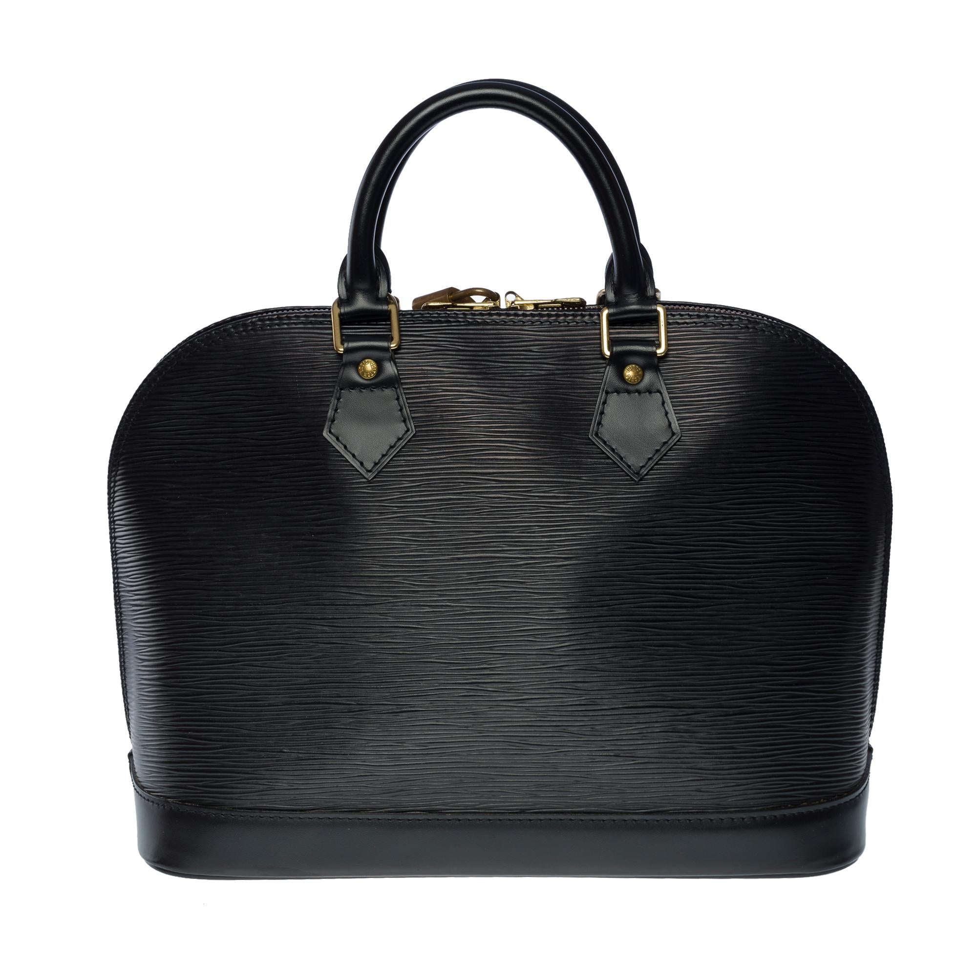 Very Chic Louis Vuitton Alma handbag in black epi leather, gold-plated metal hardware, double black leather handle for a hand-held

Double zip closure
Black canvas lining, one patch pocket
Date: 1998
Dimensions: 30 X 25 x 16 cm (11,8 x 9,8 x 6,3