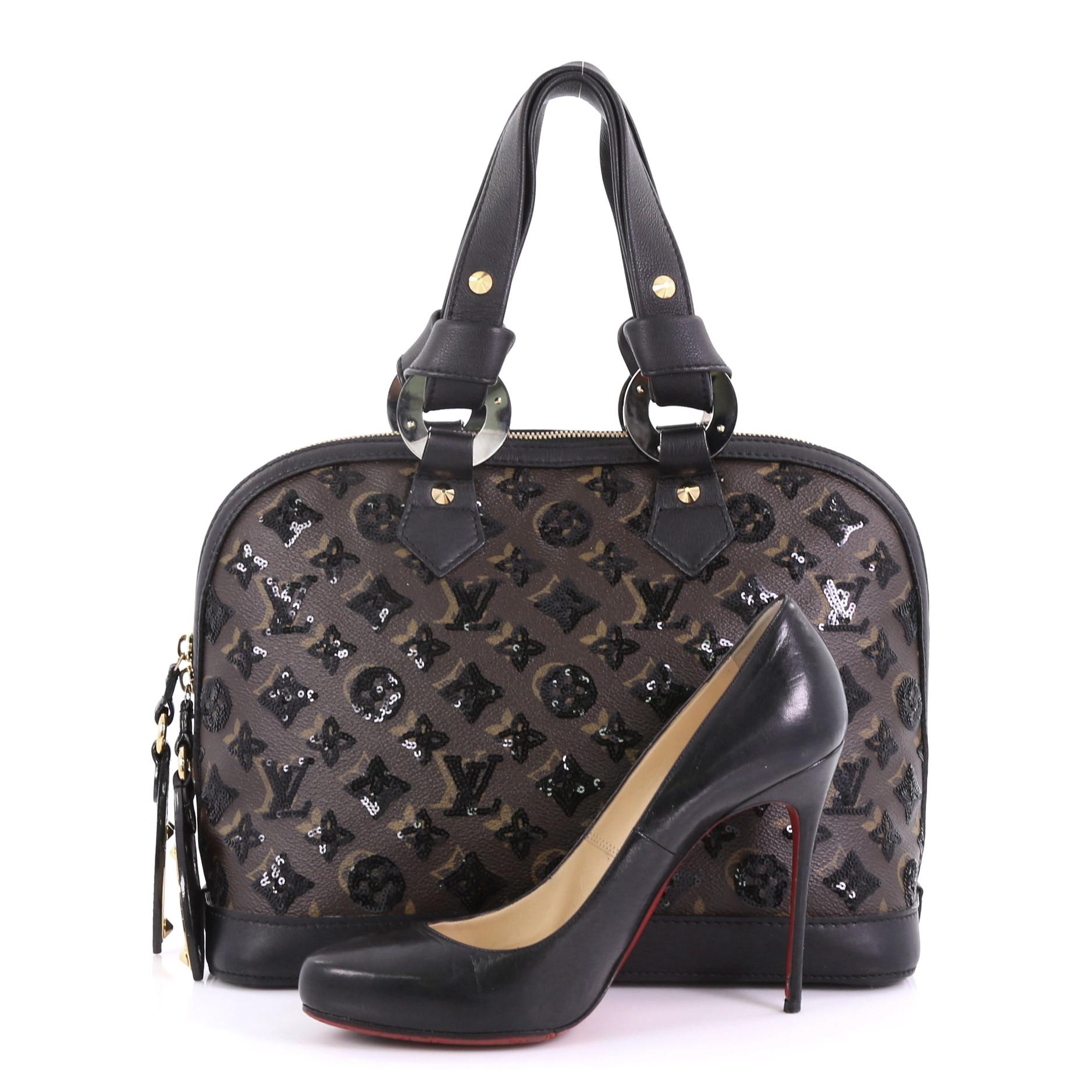 This Louis Vuitton Alma Handbag Limited Edition Monogram Eclipse Sequins PM, crafted in Brown and black Limited Edition Monogram Eclipse Sequins, features zipper pulls inspired by hotel room keys, dual leather handles with end knots, and gold and