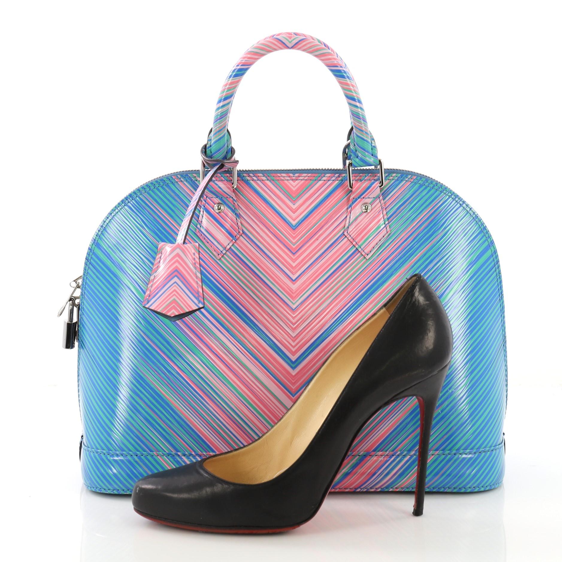 This Louis Vuitton Alma Handbag Limited Edition Tropical Epi Leather PM, crafted in multicolor epi leather, features dual rolled handles, protective base studs, tropical print, and silver-tone hardware. Its zip-around closure opens to a light blue