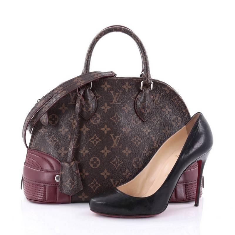 This authentic Louis Vuitton Alma Handbag Monogram Shine Canvas PM from the brand's Pre-Fall 2015 Collection is a classic style that is upgraded and perfect for all seasons. Crafted from Louis Vuitton's iconic brown monogram shine coated canvas,