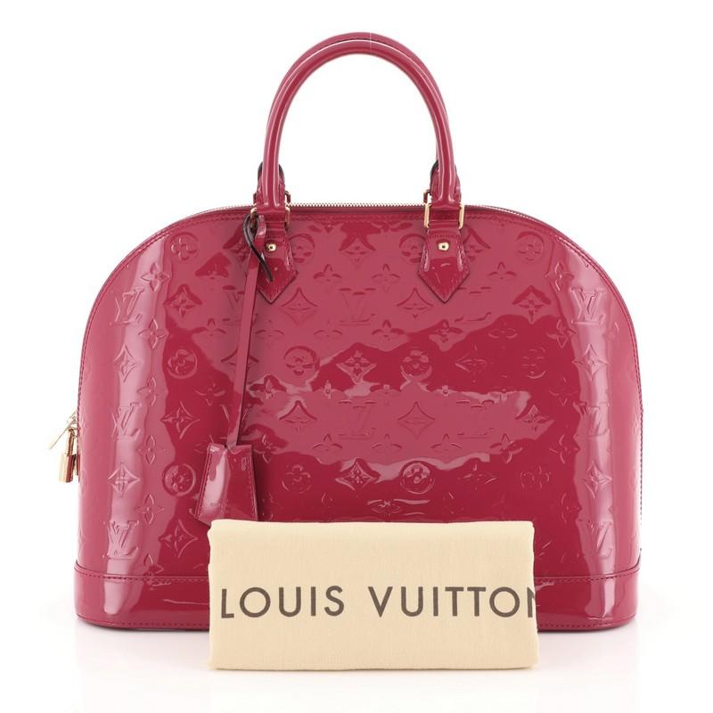 This Louis Vuitton Alma Handbag Monogram Vernis GM, crafted from pink monogram vernis leather, features dual rolled handles, protective base studs, and gold-tone hardware. Its two-way zip closure opens to a pink fabric interior with slip pockets.