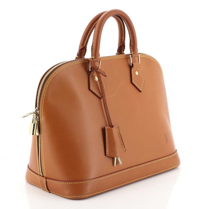 This Louis Vuitton Alma Handbag Nomade Leather PM, crafted in brown leather, features dual rolled handles and gold-tone hardware. Its all-around zip closure opens to a neutral microfiber interior with slip pockets. Authenticity code reads: FL0046.