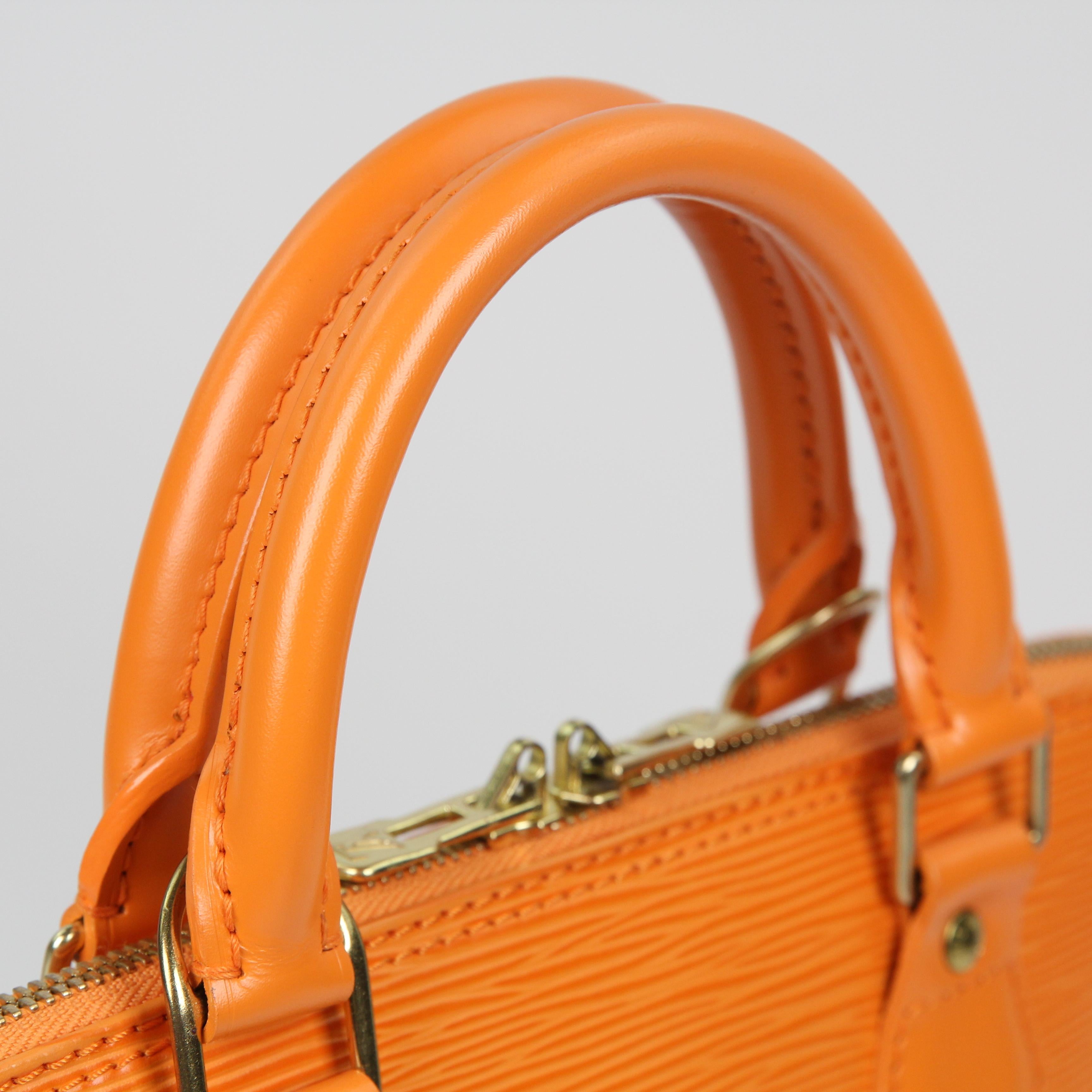 This Louis Vuitton Orange Epi Leather Alma Bag is made for anyone with impeccable taste. With its classic shape and roomy interior, this timeless piece makes a great, practical everyday bag.
The exterior Epi leather is clean and in excellent
