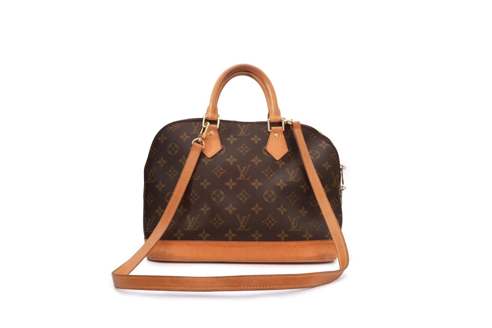 Famous Louis Vuitton Alma medium model handbag in brown monogram canvas and natural leather, gold metal trim, natural leather shoulder strap, double handle in natural leather allowing hand or shoulder carry.

Double zipper.
Inner lining in brown