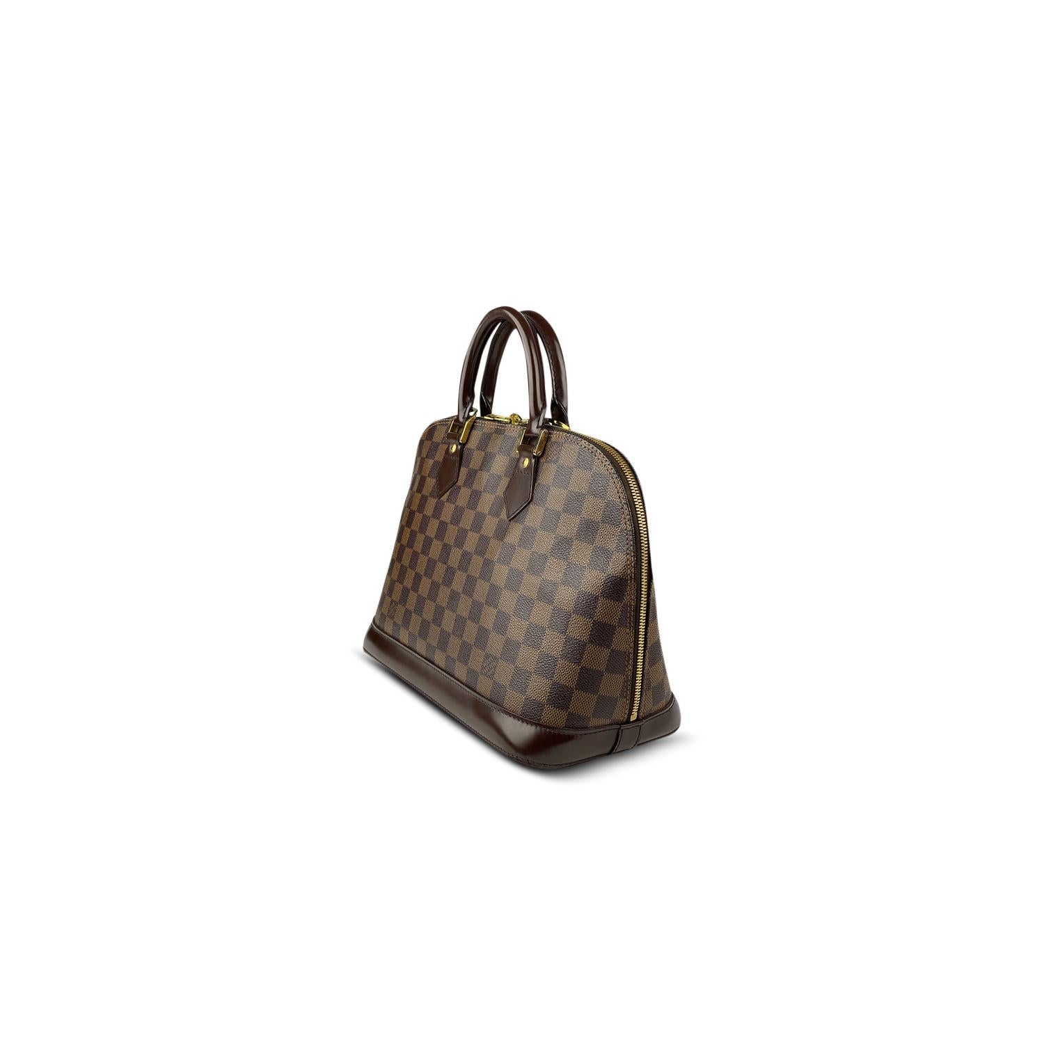 Brown Damier Ebene coated canvas Louis Vuitton Alma PM with

– Brass hardware
– Dual rolled top handles
– Tonal leather trim
– Orange canvas lining, dual pockets at interior walls and two-way zip closure at top

Overall Preloved Condition: