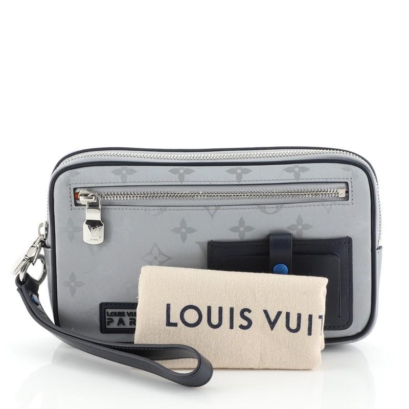 This Louis Vuitton Alpha Clutch Limited Edition Monogram Satellite Canvas, crafted in blue coated canvas, features a removable handle, bold rubber “Louis Vuitton Paris” patch, exterior zip pocket and silver-tone hardware. Its zip closure opens to an
