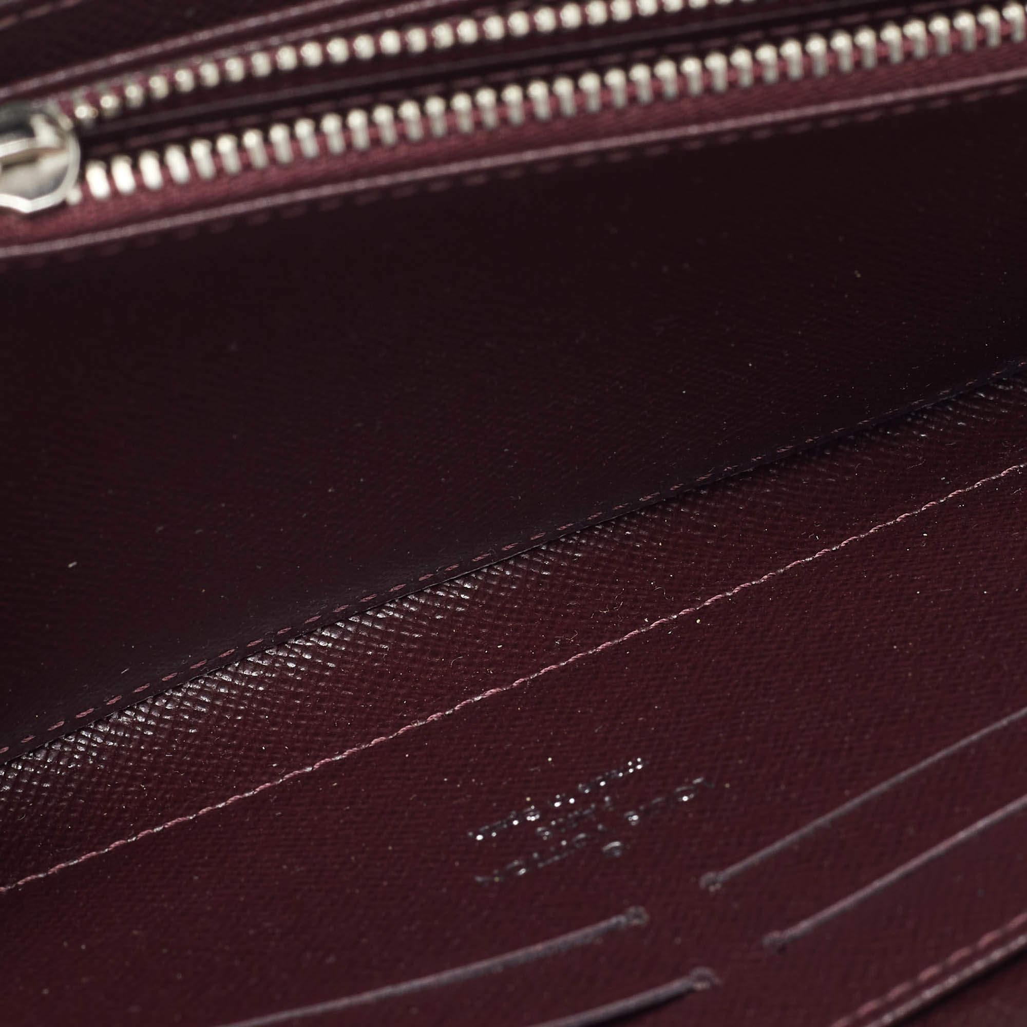 This Louis Vuitton Zippy wallet is conveniently designed for everyday use. Crafted from Electric Epi patent leather  the wallet has a wide zip closure that opens to reveal multiple slots  leather lined compartments and a zip pocket for you to neatly