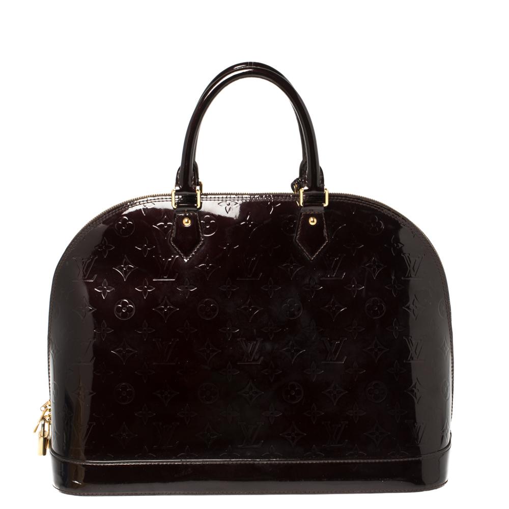 A classic from the house of Louis Vuitton, the shape of the Alma stands out. Louis Vuitton's Alma was named after the Alma Bridge that connects Paris's fashionable neighborhood. The bag is crafted from monogram Vernis leather, and it features