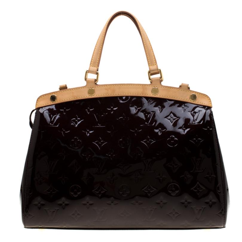 The feminine shape of Louis Vuitton's Brea is inspired by the doctor's bag. Crafted from Monogram Vernis patent leather, the bag has a perfect glossy finish. The fabric interior is spacious and it is secured by a zipper. The bag features double