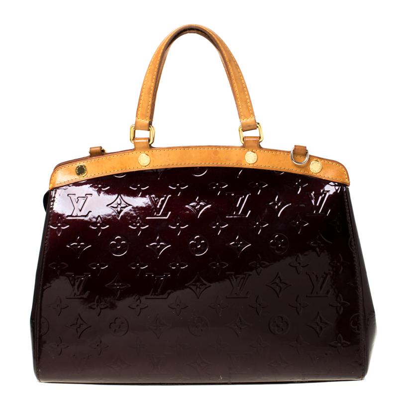 The feminine shape of Louis Vuitton's Brea is inspired by the doctor's bag. Crafted from Monogram Vernis in burgundy, the bag has a perfect finish. The fabric interior is spacious and it is secured by a zipper. The bag features double handles,