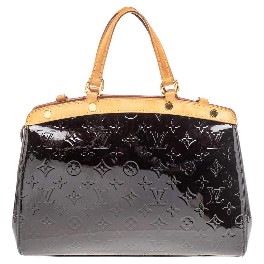 The feminine shape of Louis Vuitton's Brea is inspired by the doctor's bag. Crafted from Monogram Vernis leather, the bag has a fine finish. The fabric interior is spacious and it is secured by a zipper. The bag features double handles, protective