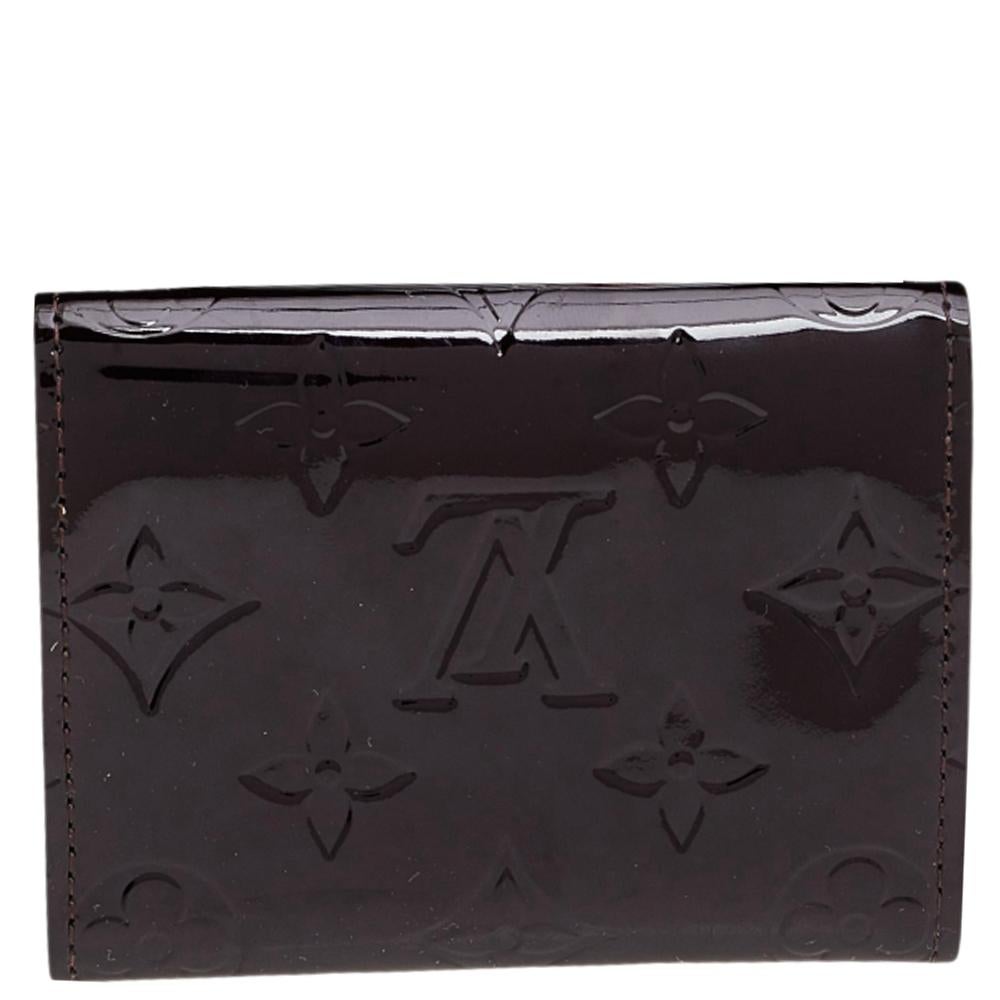 This Business card holder by Louis Vuitton is a fine accessory to add to your everyday style edit. Crafted from Monogram Vernis, it comes in a grand shade and has a leather interior to hold your essentials. A gold-tone press stud acts as the