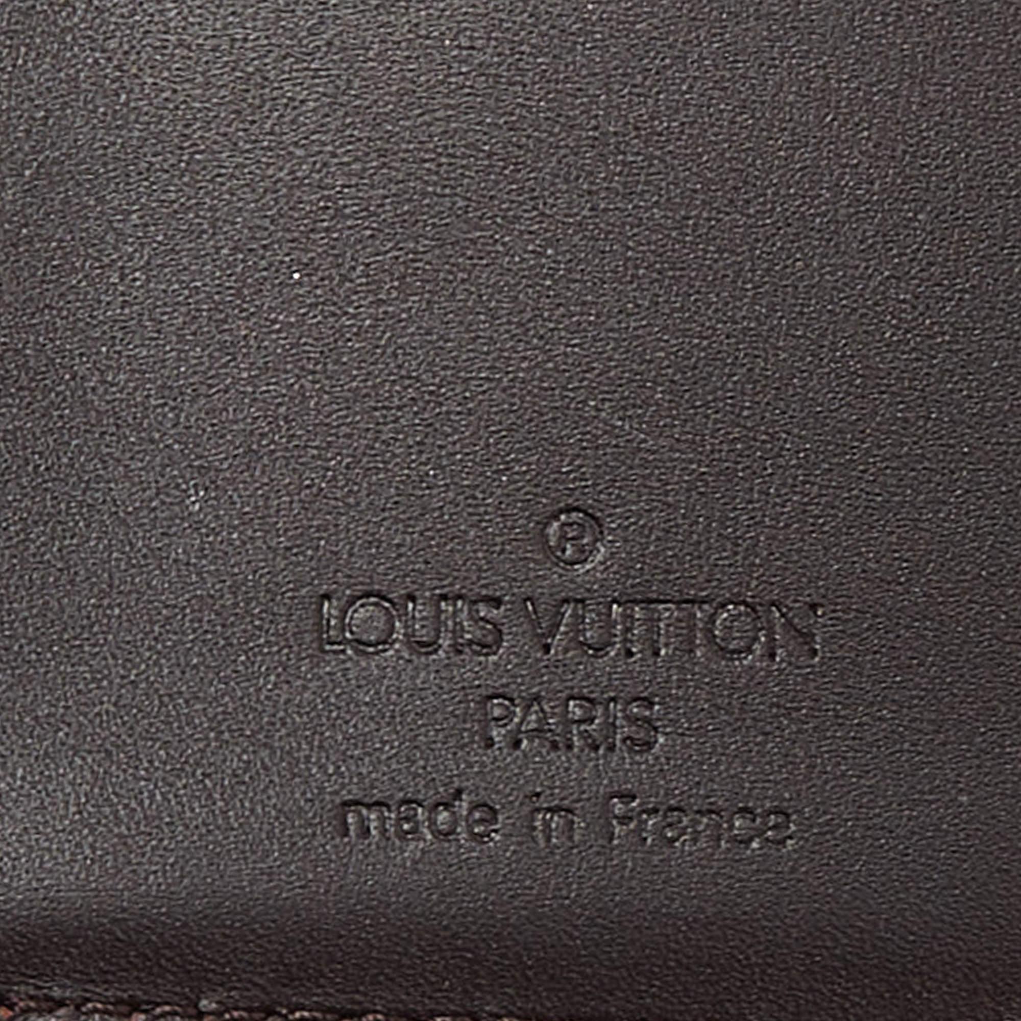 This fabulous French wallet from the house of Louis Vuitton is functional and stylish. It is made from classic Amarante monogram Vernis and lined with leather on the insides. The buttoned closure opens to multiple card slots, open compartments to
