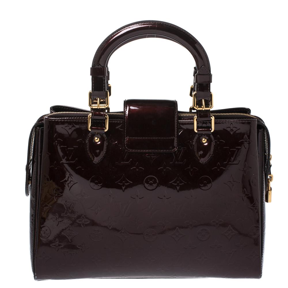 Looking for an every-day bag with just the right coat of luxury? Your quest ends here with this Melrose Avenue from Louis Vuitton. Wonderfully crafted from Monogram Vernis patent leather, the bag brings a lovely shade of burgundy, two top handles