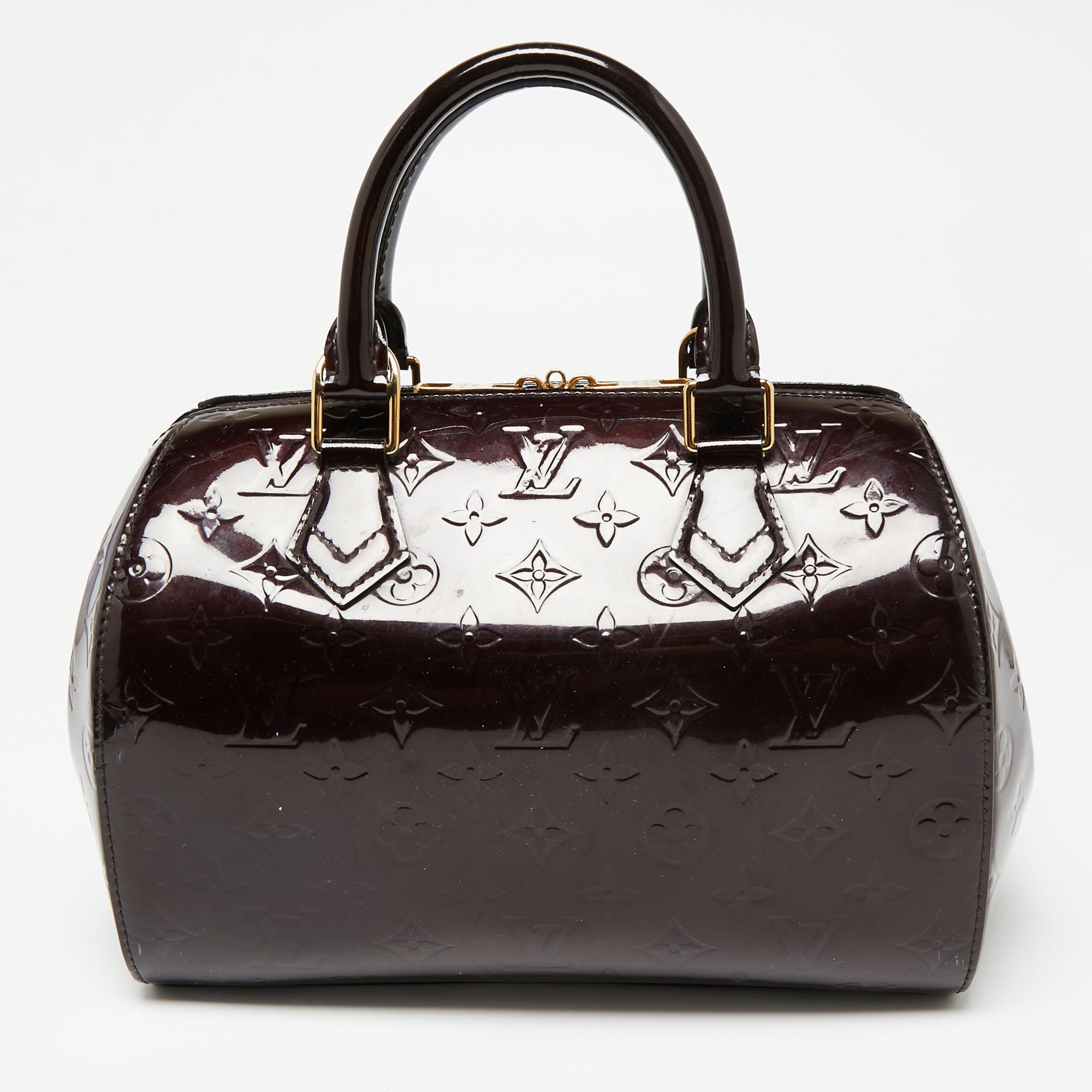 Louis Vuitton's handbags are popular owing to their high style and functionality. Crafted from beautiful monogram Vernis, the Montana bag features dual top handles, gold-tone hardware, and protective metal feet. The zip-top closure opens to a