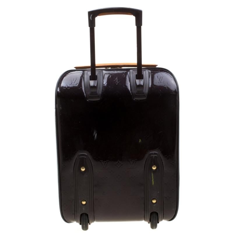 Practical and subtle to look at, this Pegase 45 suitcase from Louis Vuitton is made from burgundy Monogram Vernis patent leather which is sturdy and lightweight. Equipped with two swivel wheels that offer unrestrained movement, the bag has a top zip