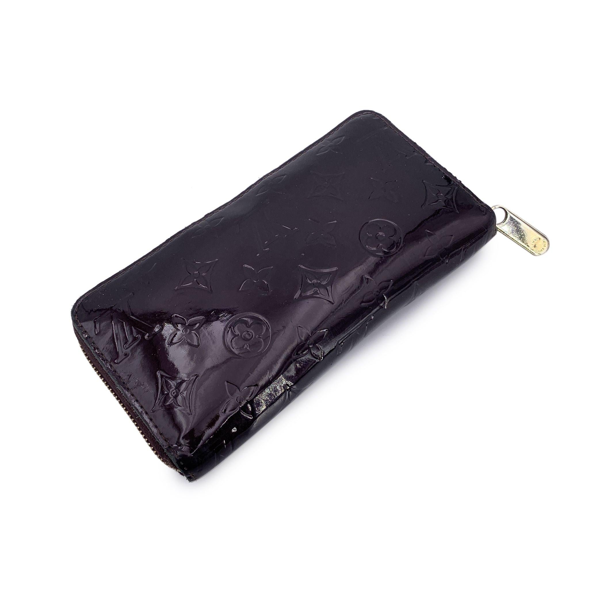 This beautiful item will come with a Certificate of Authenticity provided by Entrupy. The certificate will be provided at no further cost A true classic with a modern edge, this Louis Vuitton Monogram Vernis Zippy Wallet in rich Amarante is the