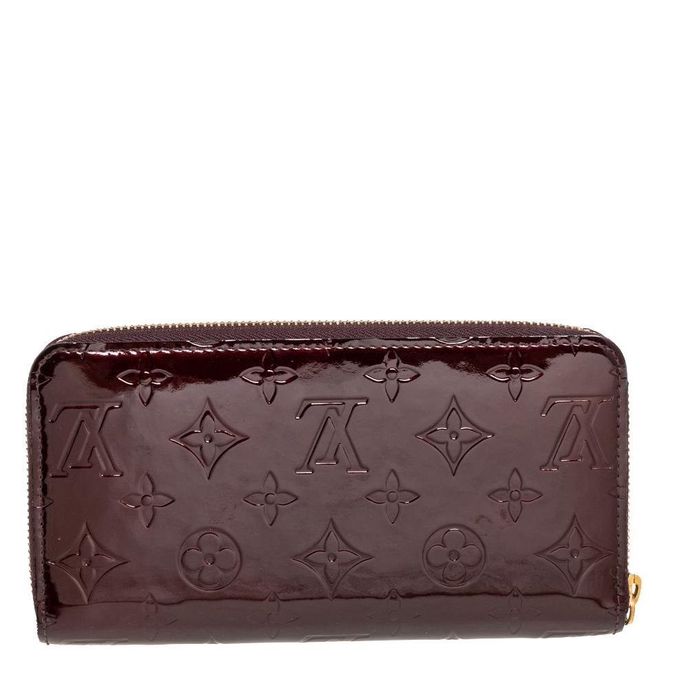 This Louis Vuitton Zippy wallet is conveniently designed for everyday use. Crafted from Monogram Vernis, the wallet has a wide zip closure that opens to reveal multiple slots, leather-lined compartments, and a zip pocket for you to neatly arrange