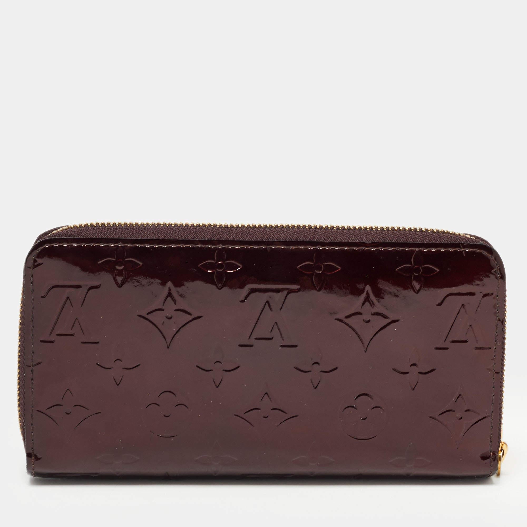 This Louis Vuitton Zippy wallet is conveniently designed for everyday use. Crafted from Monogram Vernis, the wallet has a wide zip closure that opens to reveal multiple slots, lined compartments, and a zip pocket for you to arrange your daily