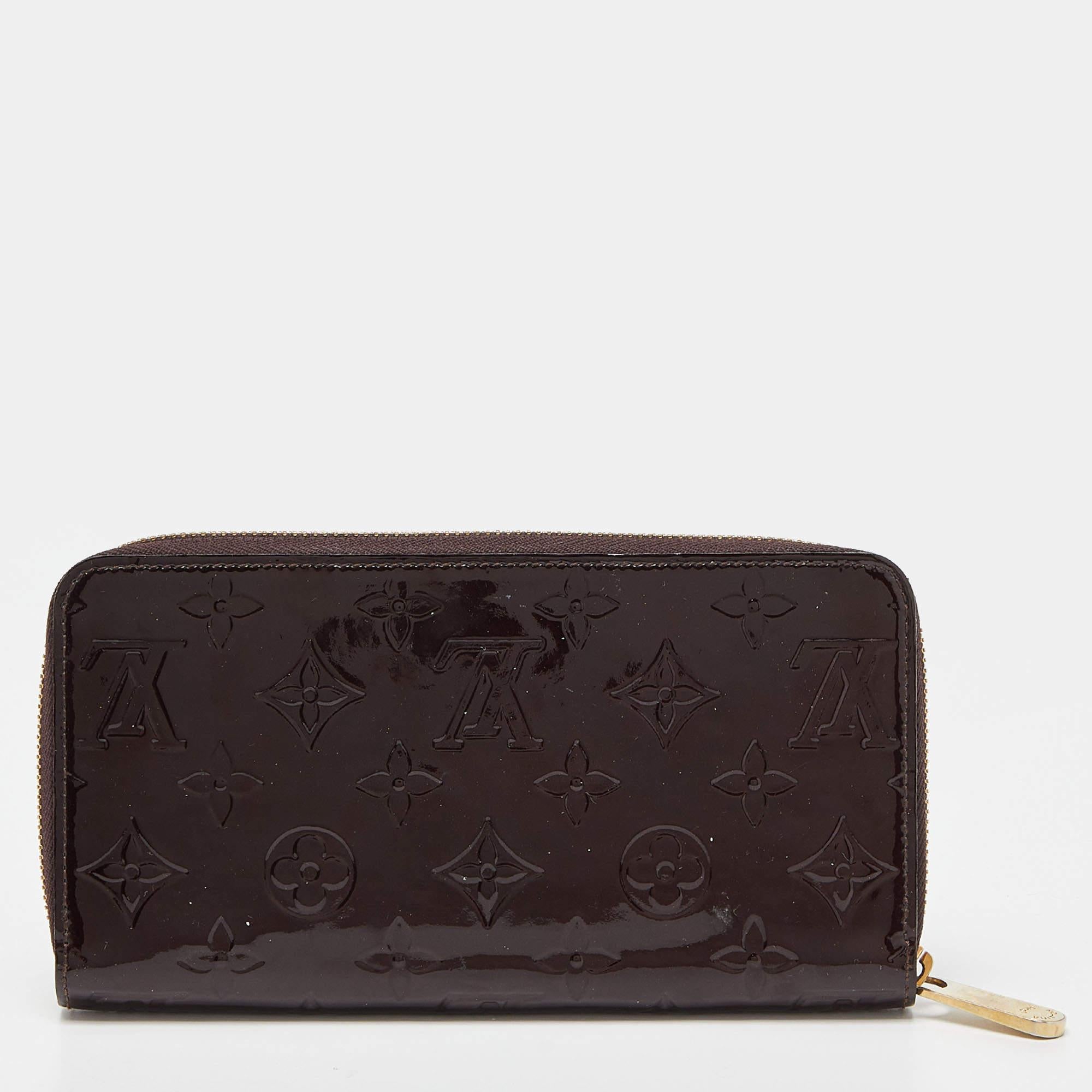 This Louis Vuitton Zippy wallet is conveniently designed for everyday use. Crafted from Amarante Monogram Vernis, the wallet has a wide zip closure that opens to reveal multiple slots, lined compartments, and a zip pocket for you to arrange your