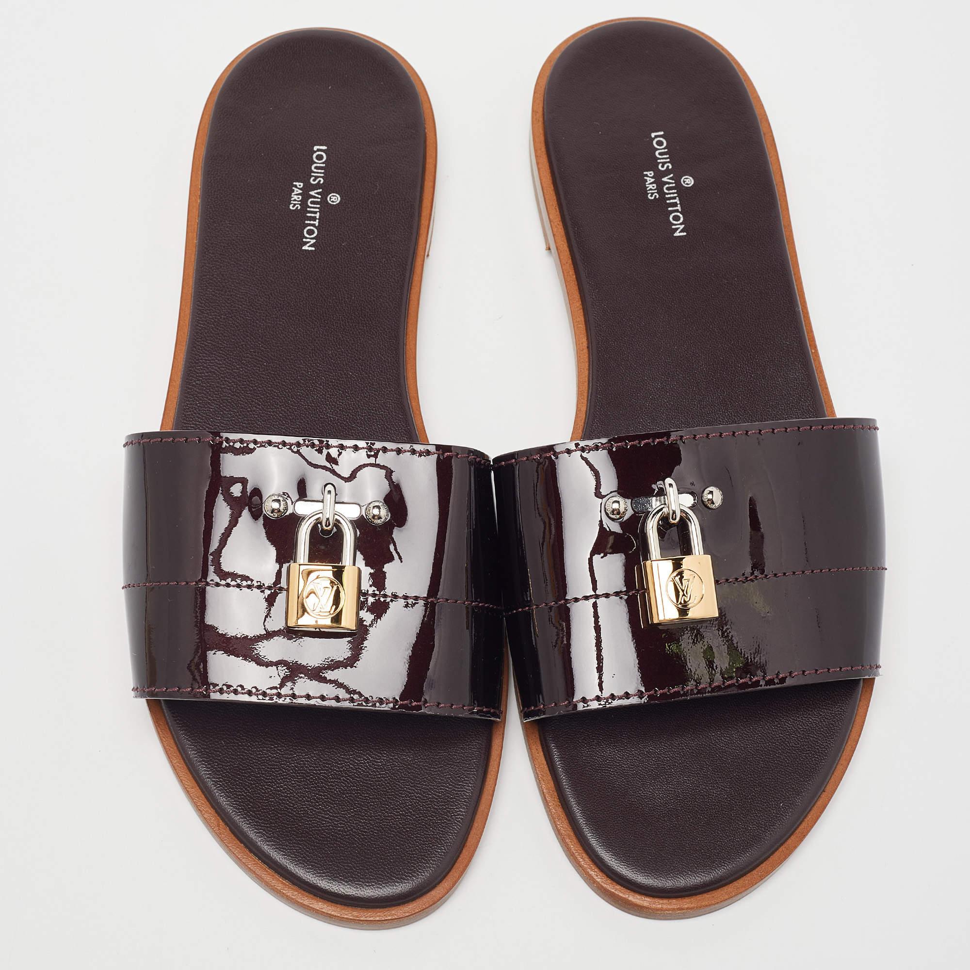 Timelessly elegant and stylish, Louis Vuitton's collections capture the effortless, nonchalant finesse of the modern woman. Crafted from patent leather, these chic Lock It sandals feature open toes and padlock accents.

Includes: Original Dustbag

