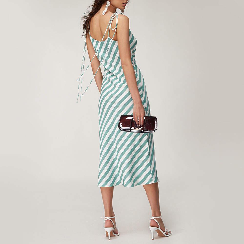 Well-crafted and overflowing with style, this Sobe clutch is from Louis Vuitton. It has a patent leather exterior, a fabric interior, and a large LV adorned on the flap. This creation will lift all your gowns and elegant outfits.

