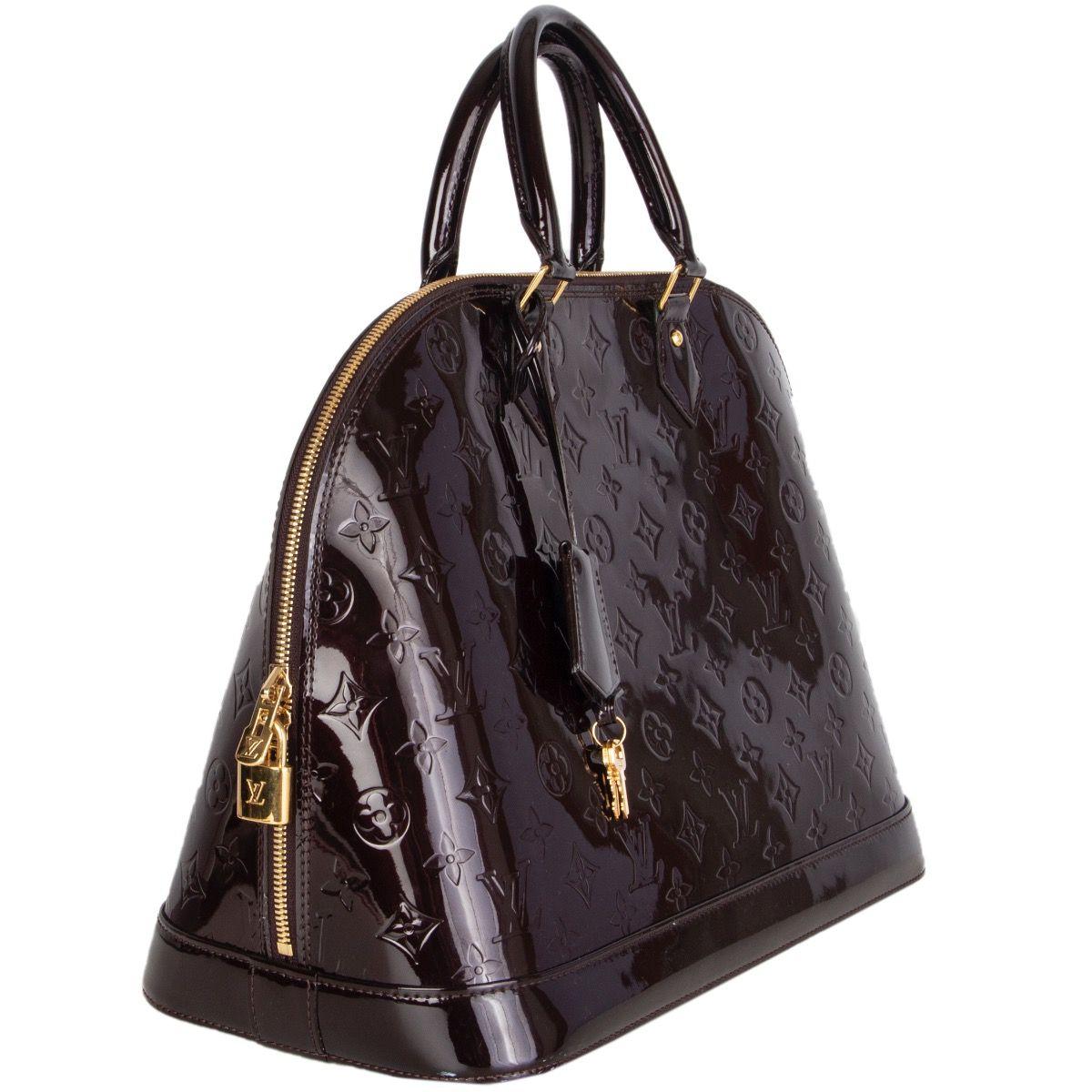 Louis Vuitton 'Alama GM' in Amarante Vernis patent leather. Closes with a double zipp on top. Lined in dark brwon canvas with two open pockets against the back. Has been carried and is in excellent condition. Comes with keys and lock.

Height 29cm